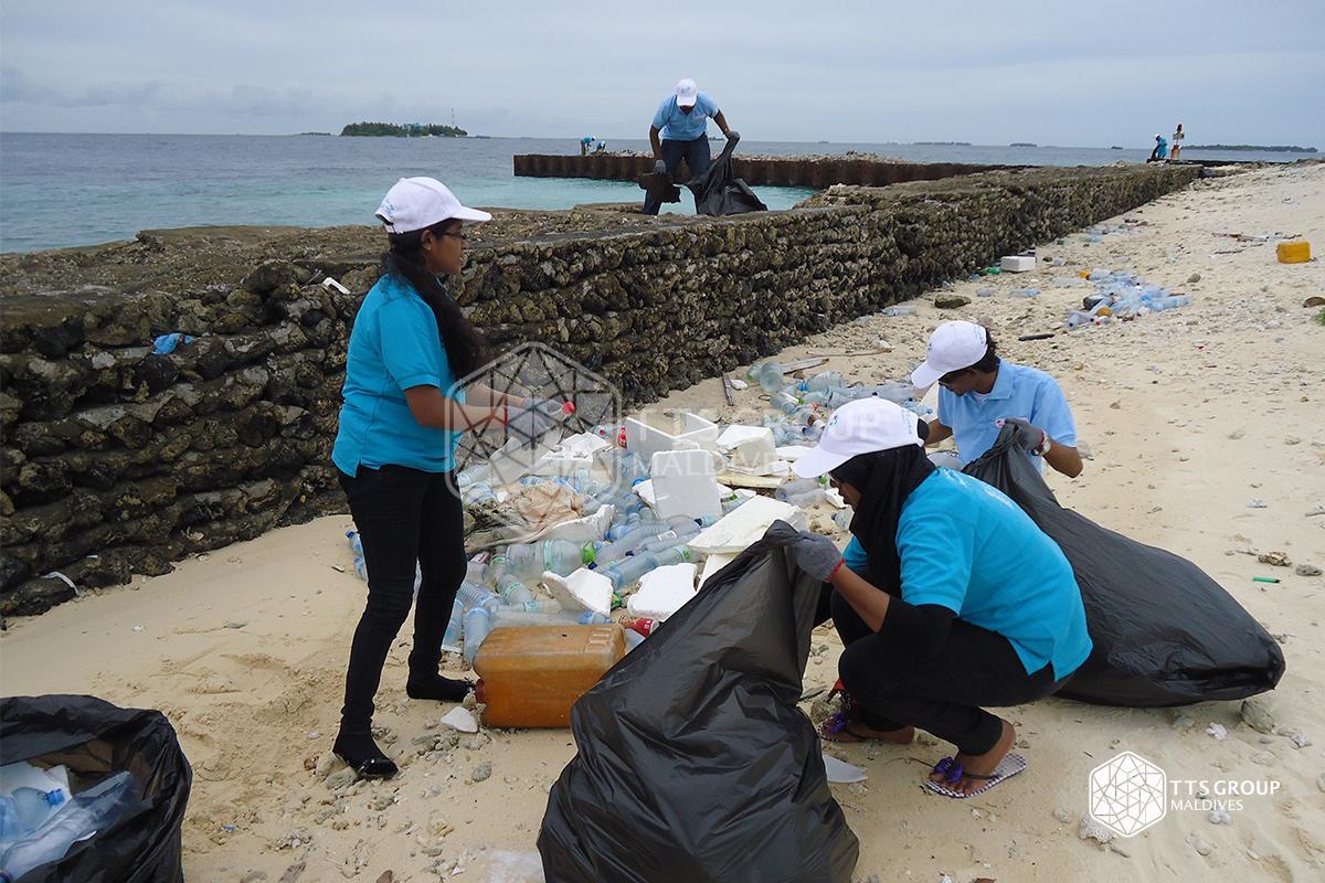 Collecting garbage Maldives beach